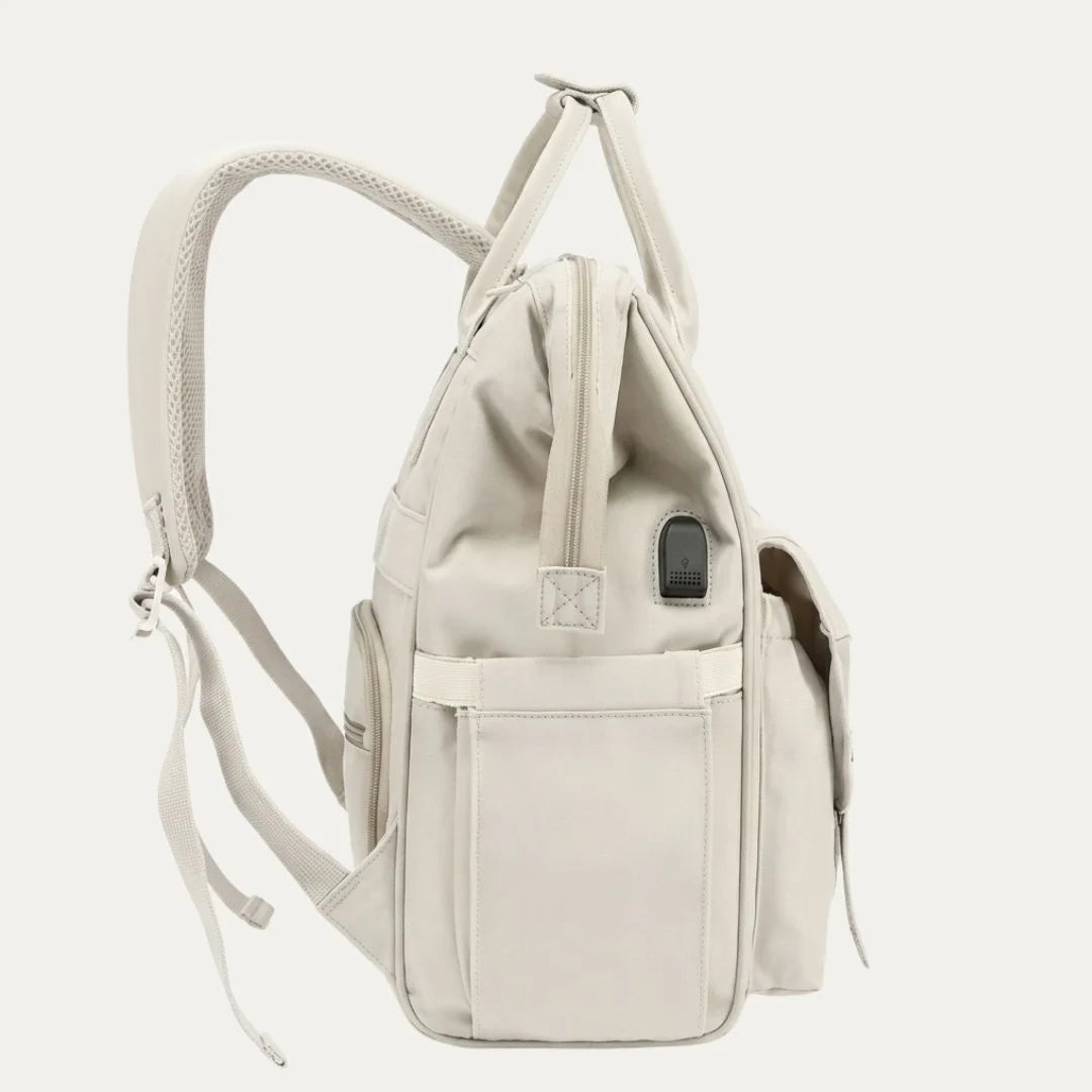 Beige backpack with multiple pockets on a light gray background