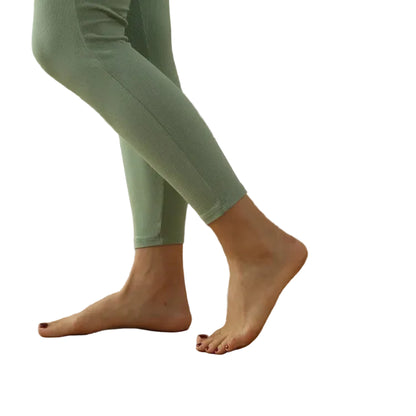 Person wearing green leggings on a white background image